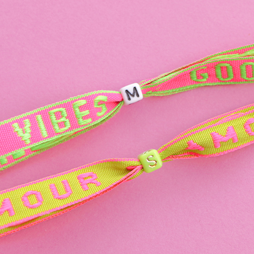 Aus neonfarbigen Schmuckb&auml;ndern mit Text trendige Armb&auml;nder machen